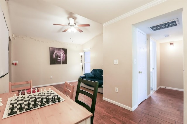 dining area featuring visible vents, baseboards, ornamental molding, wood finished floors, and a ceiling fan