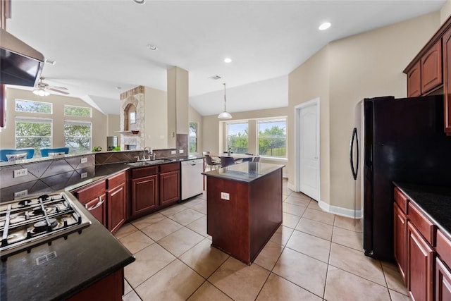 kitchen with freestanding refrigerator, a kitchen island, ceiling fan, dishwasher, and a sink