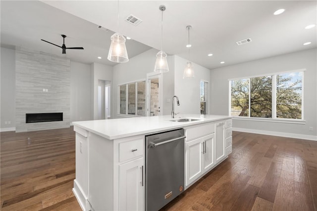 kitchen with stainless steel dishwasher, a sink, visible vents, ceiling fan, and open floor plan