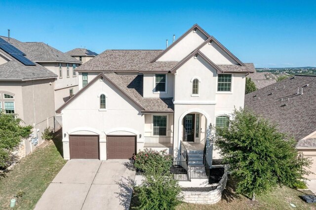 3909 Vinalopo Dr, Austin, TX 78738 - french country inspired facade with stucco siding, concrete driveway, an attached garage, and roof with shingles