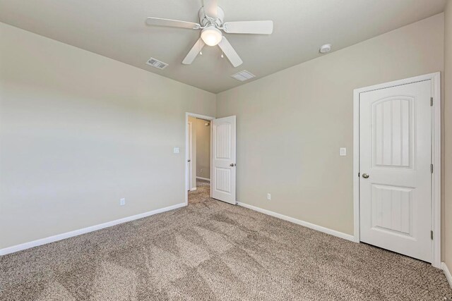 3909 Vinalopo Dr, Austin, TX 78738 - unfurnished bedroom with carpet floors, baseboards, and a ceiling fan