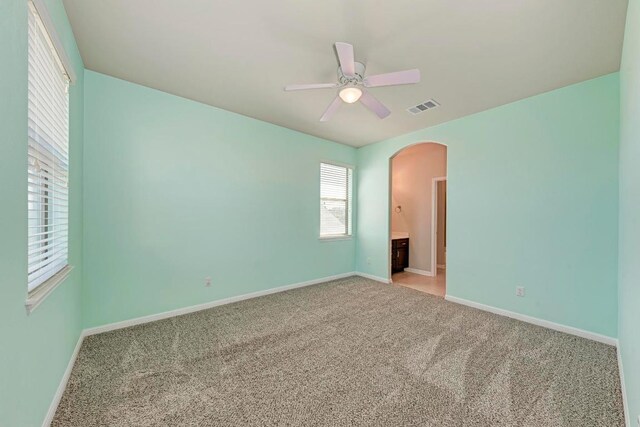 3909 Vinalopo Dr, Austin, TX 78738 - unfurnished bedroom with arched walkways, carpet flooring, and baseboards