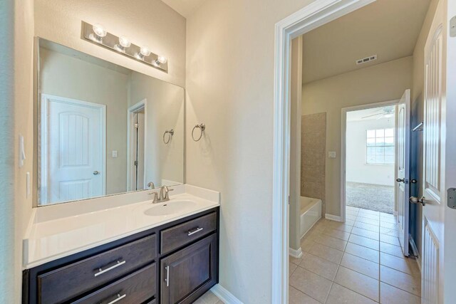 3909 Vinalopo Dr, Austin, TX 78738 - bathroom with vanity, tile patterned floors, baseboards, and a ceiling fan