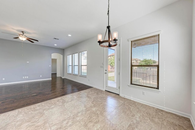3909 Vinalopo Dr, Austin, TX 78738 - spare room with a chandelier, a ceiling fan, arched walkways, and baseboards