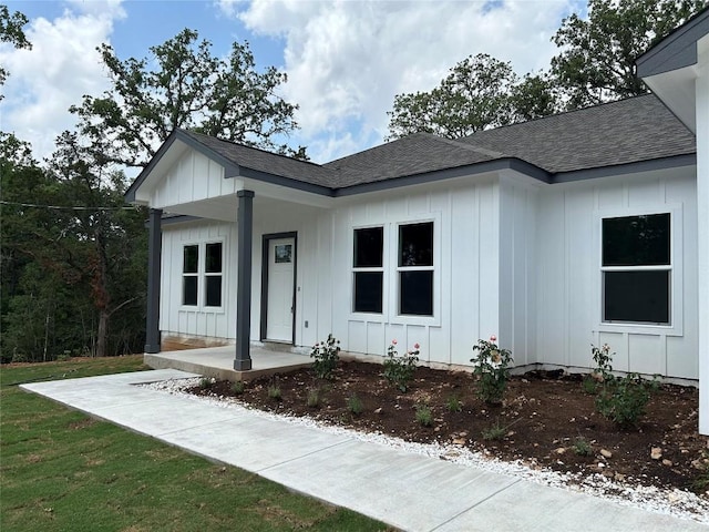 128 Heleakala Dr, Bastrop, TX 78602 - view of front of house featuring board and batten siding and a shingled roof