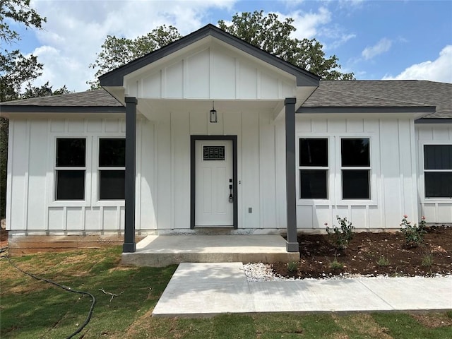 128 Heleakala Dr, Bastrop, TX 78602 - view of front of property featuring board and batten siding, a shingled roof, and covered porch