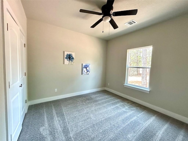 128 Heleakala Dr, Bastrop, TX 78602 - carpeted empty room with a ceiling fan, baseboards, and visible vents