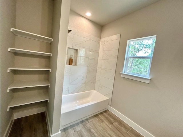 128 Heleakala Dr, Bastrop, TX 78602 - bathroom with baseboards, recessed lighting, wood finished floors, and  shower combination