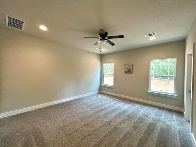 128 Heleakala Dr, Bastrop, TX 78602 - carpeted empty room featuring a ceiling fan, visible vents, and a wealth of natural light