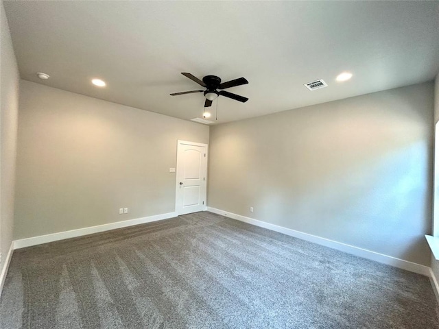 128 Heleakala Dr, Bastrop, TX 78602 - spare room featuring baseboards, a ceiling fan, dark carpet, and visible vents