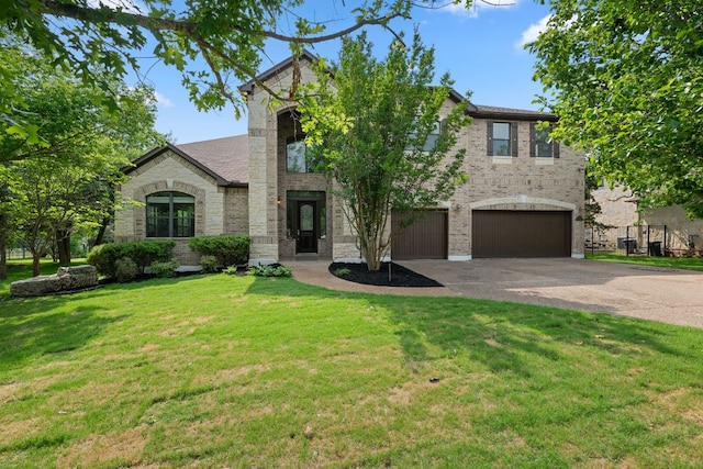 view of front of property with brick siding, a front yard, concrete driveway, and an attached garage