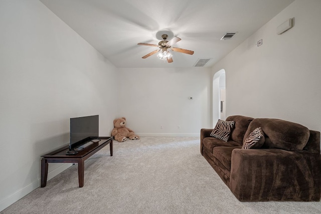 living room with visible vents, ceiling fan, carpet floors, baseboards, and arched walkways