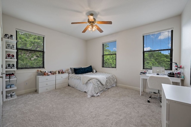 carpeted bedroom featuring a ceiling fan and baseboards