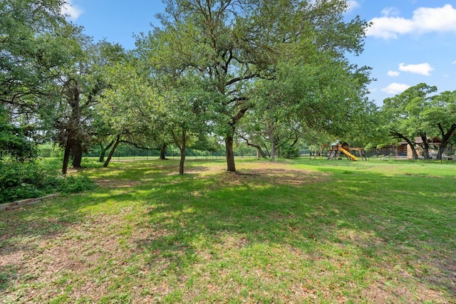 view of yard with playground community and fence