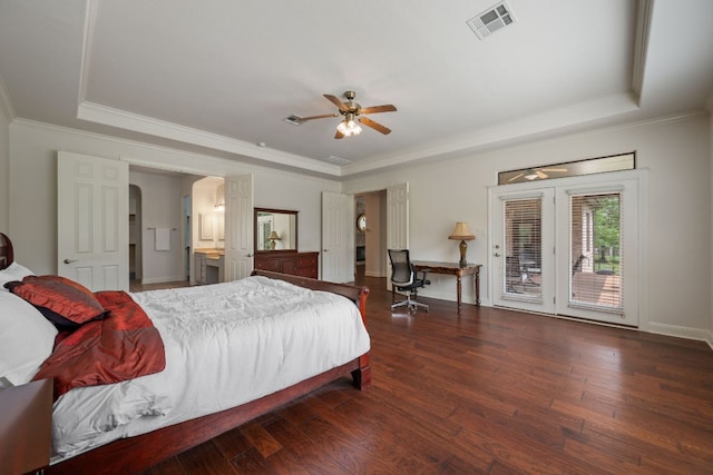 bedroom with wood-type flooring, access to exterior, visible vents, and a tray ceiling