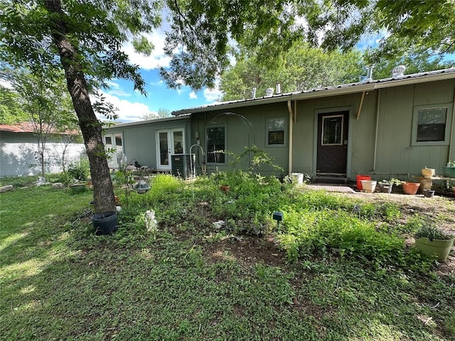 201 E Bluebonnet Ln, Johnson City, TX 78636 - back of house with french doors and metal roof