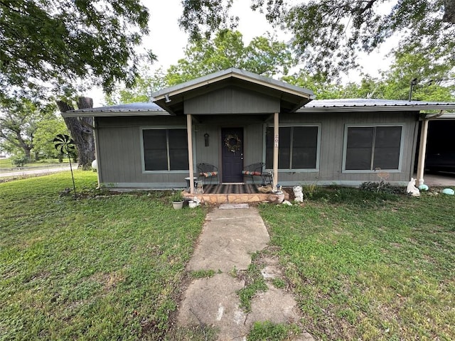 201 E Bluebonnet Ln, Johnson City, TX 78636 - view of front of house featuring a front lawn and metal roof