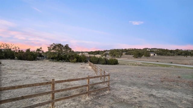 view of yard with a rural view and fence