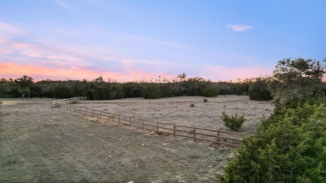 view of yard featuring a rural view and fence