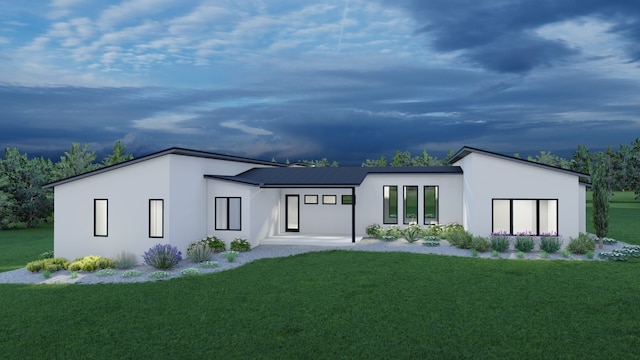 exterior space featuring stucco siding, a front yard, and metal roof