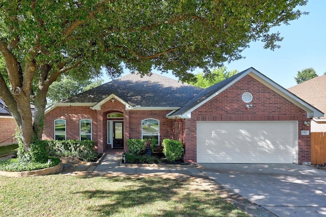 view of front of house with brick siding, a shingled roof, a garage, a front yard, and concrete driveway