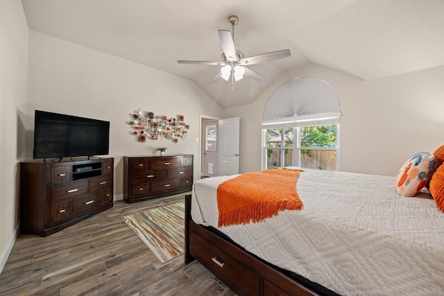 bedroom with ceiling fan, vaulted ceiling, wood finished floors, and baseboards