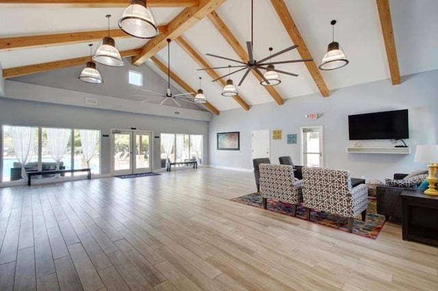 living area featuring beamed ceiling, french doors, wood finished floors, a ceiling fan, and high vaulted ceiling