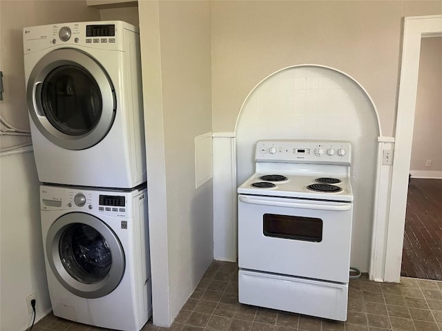 washroom featuring stacked washer and dryer and laundry area