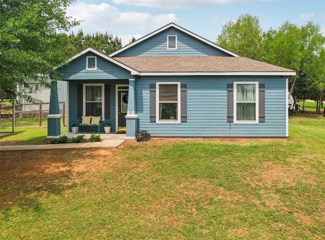 103 Bonham Ln, Paige, TX 78659 - bungalow with a porch, a front yard, and roof with shingles