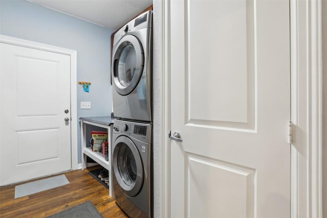 103 Bonham Ln, Paige, TX 78659 - laundry area with stacked washing machine and dryer and dark wood-style flooring