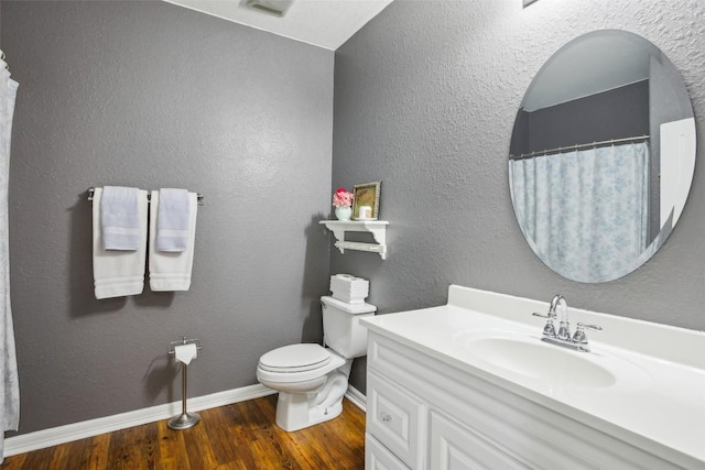103 Bonham Ln, Paige, TX 78659 - full bath with wood finished floors, vanity, toilet, and baseboards