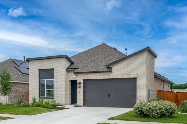 576 Billowing Way, Kyle, TX 78640 - view of front facade featuring brick siding, a garage, a shingled roof, fence, and concrete driveway