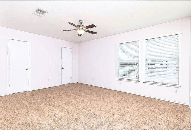 13520 Coomes Dr, Del Valle, TX 78617 - unfurnished bedroom featuring carpet floors, two closets, and ceiling fan