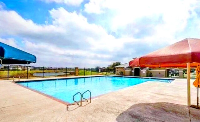 13520 Coomes Dr, Del Valle, TX 78617 - community pool with a patio