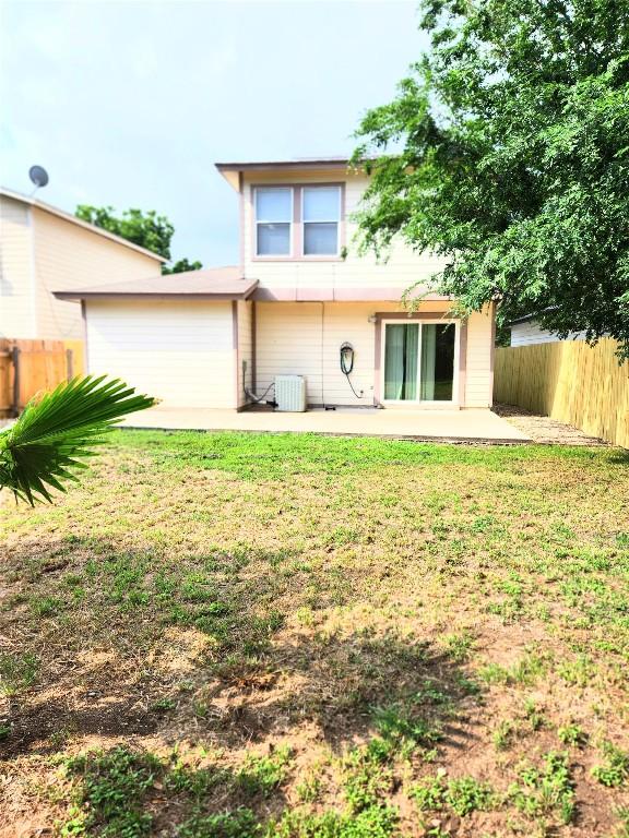 13520 Coomes Dr, Del Valle, TX 78617 - rear view of property featuring a patio and a garage