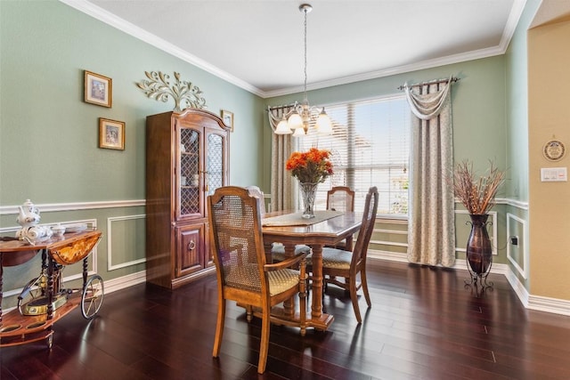 104 Emory Peak Trl, Georgetown, TX 78633 - dining space with a chandelier, dark wood-style floors, ornamental molding, and wainscoting