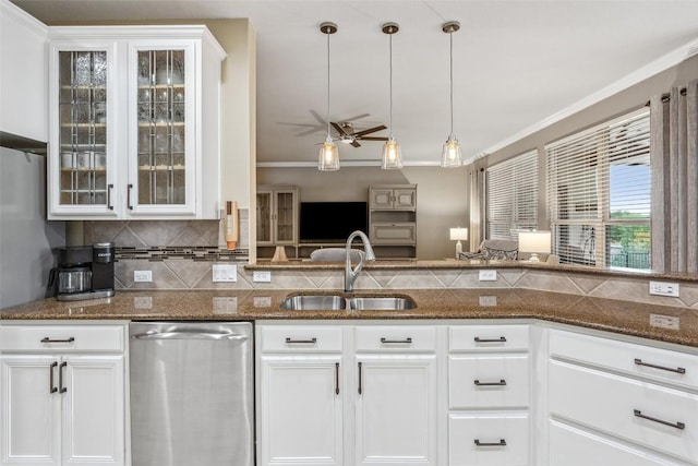 104 Emory Peak Trl, Georgetown, TX 78633 - kitchen with stainless steel dishwasher, backsplash, a ceiling fan, glass insert cabinets, and ornamental molding