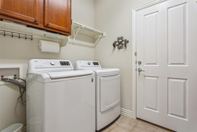 104 Emory Peak Trl, Georgetown, TX 78633 - laundry area featuring cabinet space, washing machine and dryer, and light tile patterned floors