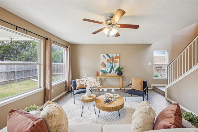 4108 Whitecrest Cv, Round Rock, TX 78681 - living room with wood finished floors, stairway, a ceiling fan, and a textured ceiling