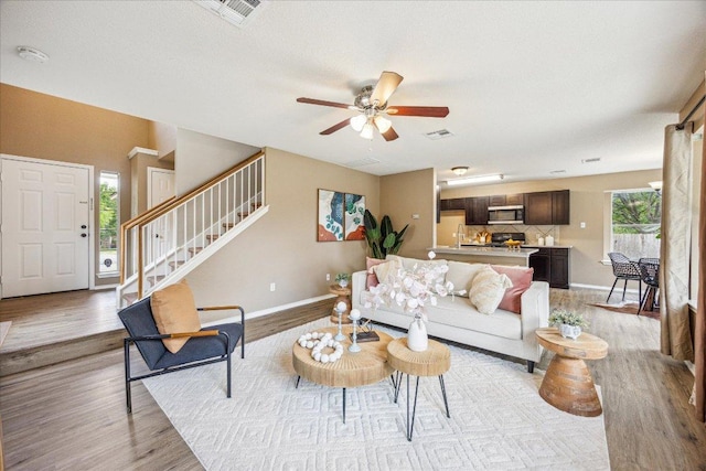 4108 Whitecrest Cv, Round Rock, TX 78681 - living area with light wood-style floors, stairs, and a ceiling fan