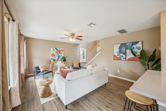 4108 Whitecrest Cv, Round Rock, TX 78681 - living area featuring wood finished floors, stairs, ceiling fan, and a textured ceiling
