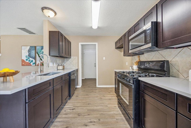 4108 Whitecrest Cv, Round Rock, TX 78681 - kitchen featuring stainless steel microwave, gas stove, light countertops, light wood-style flooring, and decorative backsplash