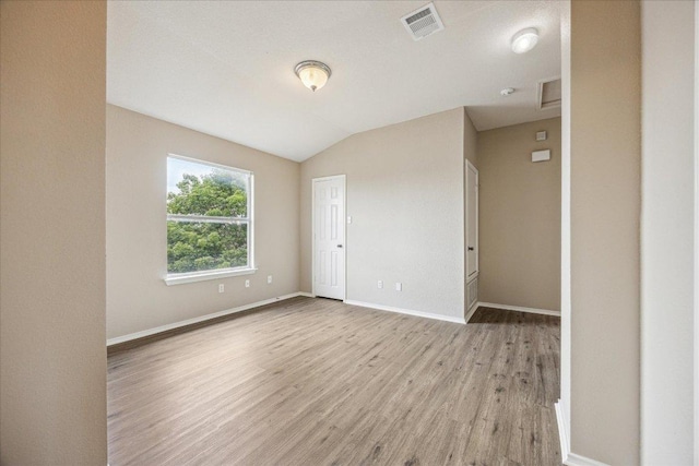 4108 Whitecrest Cv, Round Rock, TX 78681 - unfurnished room with light wood-type flooring, vaulted ceiling, and a smoke detector