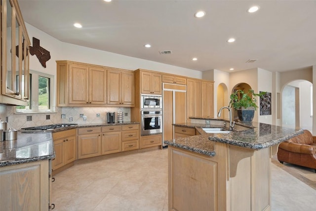 7800 Aspen Highlands Dr, Austin, TX 78746 - kitchen featuring a sink, built in appliances, arched walkways, recessed lighting, and backsplash