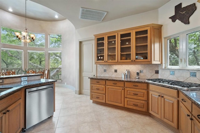 7800 Aspen Highlands Dr, Austin, TX 78746 - kitchen featuring visible vents, brown cabinetry, dark stone counters, and stainless steel appliances
