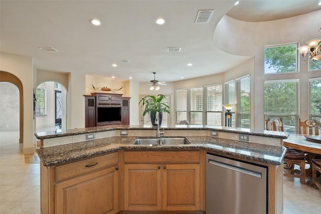7800 Aspen Highlands Dr, Austin, TX 78746 - kitchen featuring stainless steel dishwasher, a sink, arched walkways, and visible vents