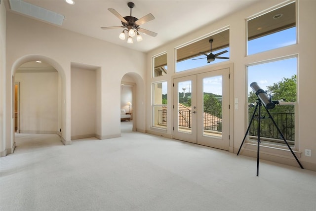 7800 Aspen Highlands Dr, Austin, TX 78746 - entryway featuring arched walkways, carpet flooring, a ceiling fan, and plenty of natural light