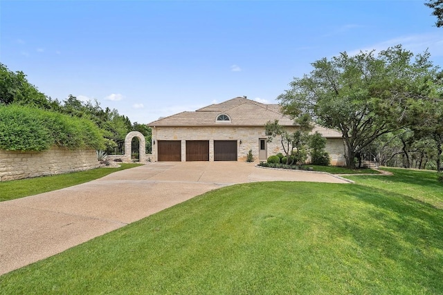 7800 Aspen Highlands Dr, Austin, TX 78746 - french provincial home with stone siding, an attached garage, a front yard, and concrete driveway