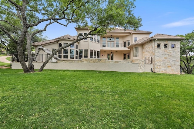 7800 Aspen Highlands Dr, Austin, TX 78746 - back of property featuring a balcony, stucco siding, a yard, and stone siding