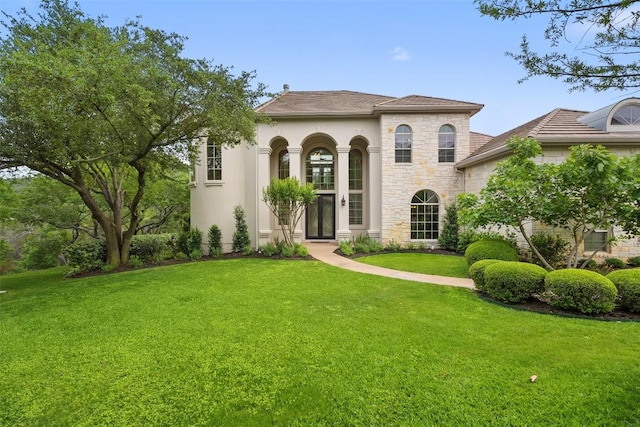 7800 Aspen Highlands Dr, Austin, TX 78746 - view of front of home featuring a front yard, stone siding, and stucco siding